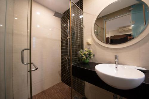 河内Omina Hanoi Hotel & Travel的一间带水槽和镜子的浴室