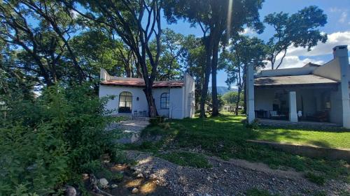 圣洛伦索La Justina - Casa de Campo en San Lorenzo的前面有树木的白色房子