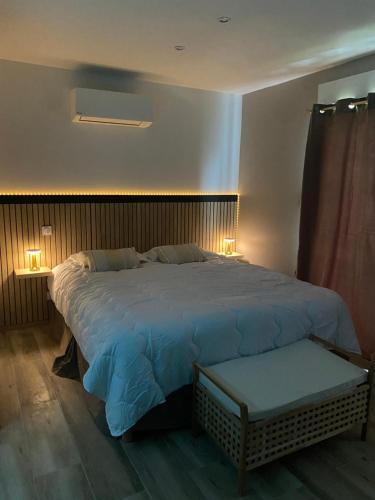 Saint-VictoretCote spa suite nord的一间卧室配有一张大床和两盏灯。