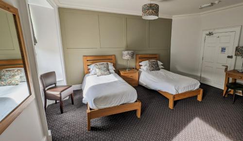 霍伊斯The White Hart Inn, Hawes的小房间设有两张床和椅子