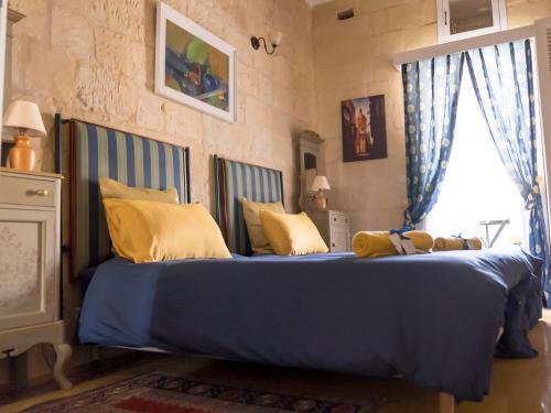 比尔古The Knight - Historical terraced house overlooking the central square的一间卧室配有一张带黄色枕头的大型蓝色床