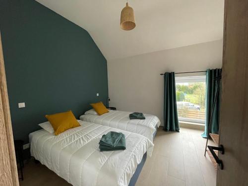 西内La Grange d'Haversin的配有两张床的客房,设有绿色的墙壁和窗户
