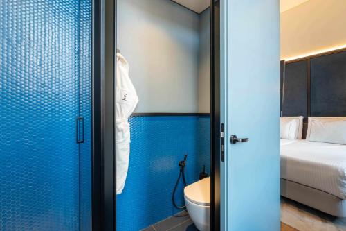 里斯本The Editory Riverside Hotel, an Historic Hotel的一间带卫生间和蓝色墙壁的浴室