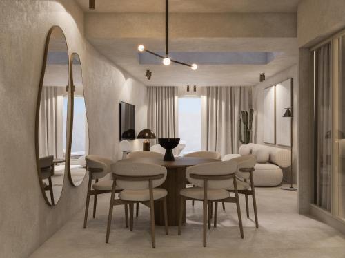 易莫洛林安德罗尼斯概念健康度假村的客厅设有餐桌和椅子