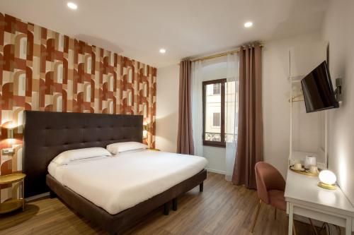 罗马Amalia Suites by Remember Rome的一间卧室设有一张大床和一个窗户。