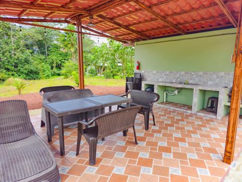 福尔图纳Confort Arenal的庭院配有桌椅和壁炉。