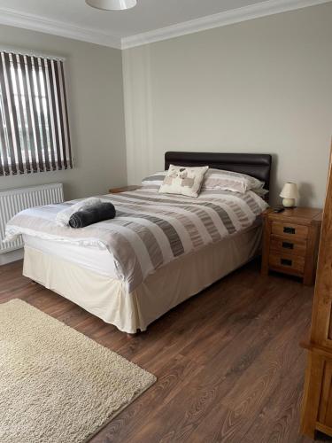 TillinghamOAK LODGE的一间卧室设有一张大床,铺有木地板