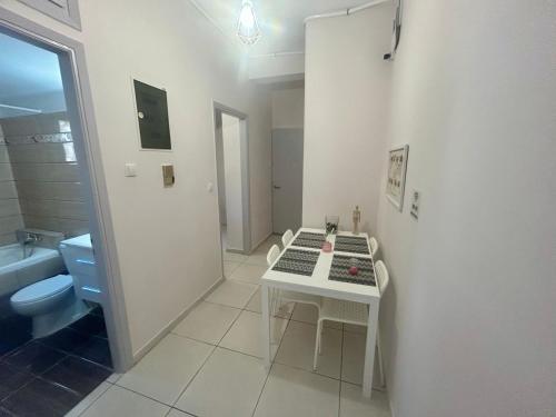阿特米达AKTIS apartment 3 near airport的白色的浴室设有桌子和卫生间。