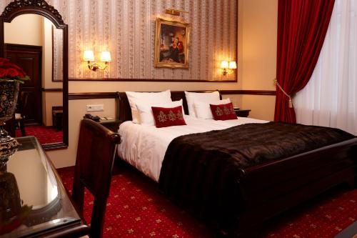 杜塞尔多夫Hotel Villa Achenbach的一间卧室配有一张铺有红地毯的大床