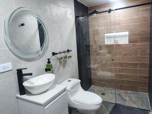 波哥大Hotel a resting place 1 AEROPUERTO的浴室配有卫生间、盥洗盆和淋浴。
