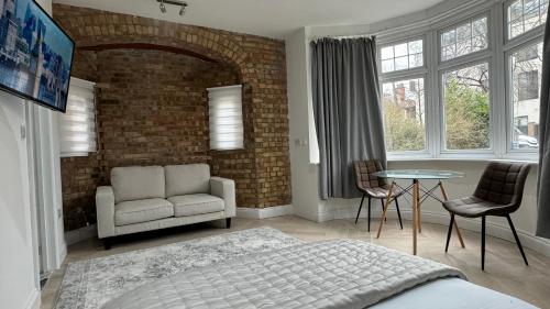 哈罗London Studios and Suites的一间卧室配有一张床、一把椅子和一张桌子