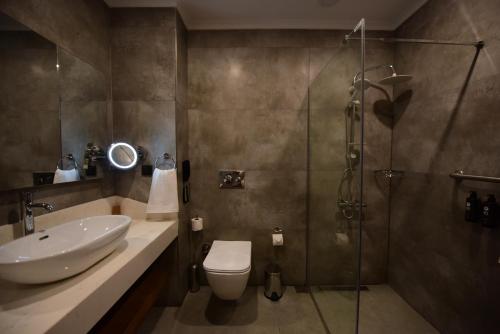伯萨Ramada by Wyndham Karacabey的带淋浴、卫生间和盥洗盆的浴室