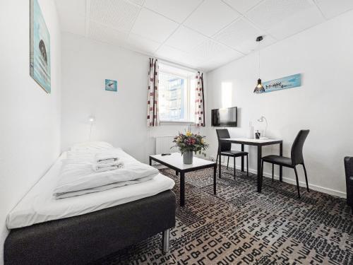 努克Nordbo in Centrum的卧室配有一张床和一张桌子及椅子