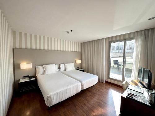 巴塞罗那泽尼特巴塞罗那酒店的酒店客房设有一张大床和一台电视。