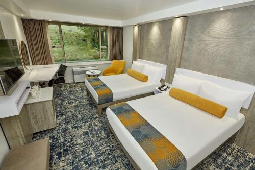 乌姆塔塔Garden Court Mthatha的酒店客房配有两张床和一张书桌