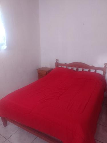 普尔马马尔卡Alojamiento familiar doña justa的一间卧室配有红色的床和红色毯子