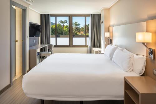 卡塔赫纳B&B HOTEL Cartagena Cartagonova的一间设有大床和窗户的酒店客房
