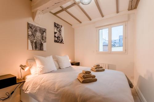 鲁昂Villa Caron - Appartements haut de gamme avec chambre hyper centre的卧室配有白色床和毛巾