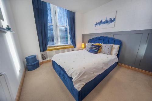 阿伯丁Guild Street Apartment ✪ Grampian Lettings Ltd的一间卧室配有蓝色的床和蓝色床头板