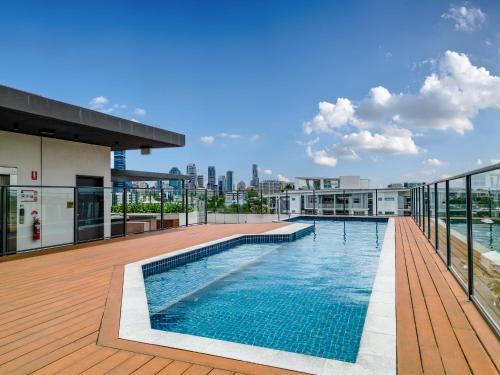 布里斯班Brisbane Luxury Gabba Apartment的建筑物屋顶上的游泳池