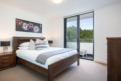 悉尼MadeComfy Executive & Stylish Inner-City Apartment的一间卧室设有一张床和一个大窗户