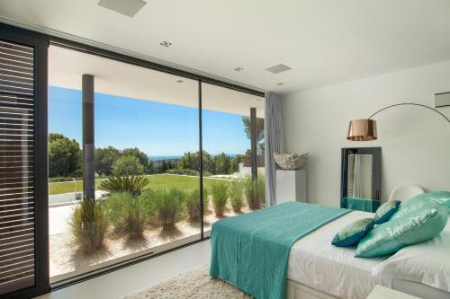 圣何塞德萨塔莱阿Villa Milane - San Jose的一间卧室设有一张床和一个大窗户