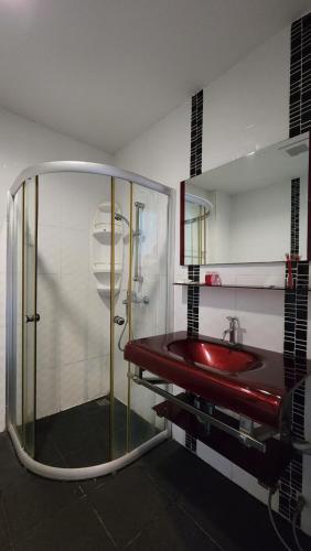 乔木提恩海滩Valhalla Pattaya的浴室设有玻璃淋浴间和红色水槽