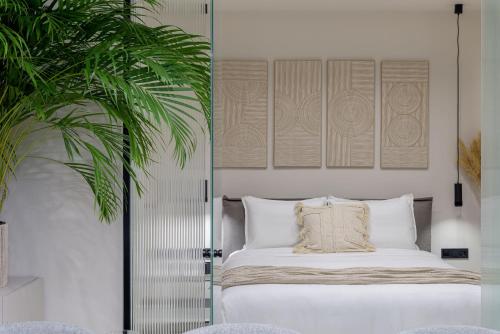 雅典Penthouse W/ View & Plunge Pool的一间卧室配有一张床和盆栽植物