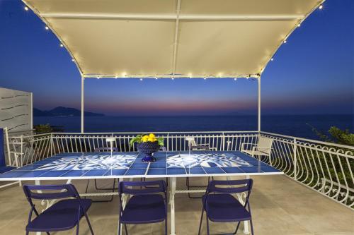 马萨鲁布朗斯AMORE RENTALS - Villa Domus Franca的海景阳台上的桌子