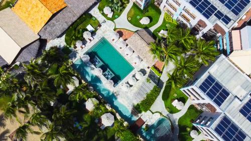 瓜斯贝拉什Hotel Varandas Beach的享有游泳池和棕榈树的上方景色