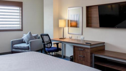 奥夫雷贡城Holiday Inn Express & Suites - Ciudad Obregon, an IHG Hotel的酒店客房配有书桌和椅子