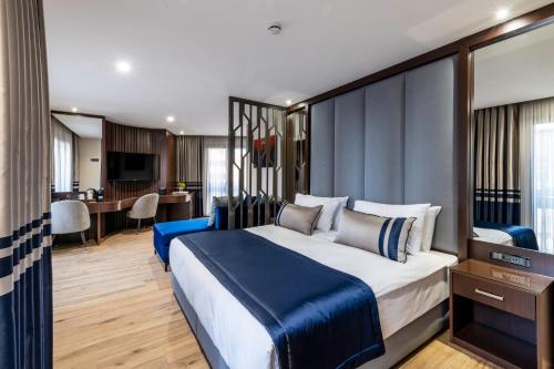 伊斯坦布尔Aprilis Deluxe Hotel的一间卧室配有一张大床和一张书桌
