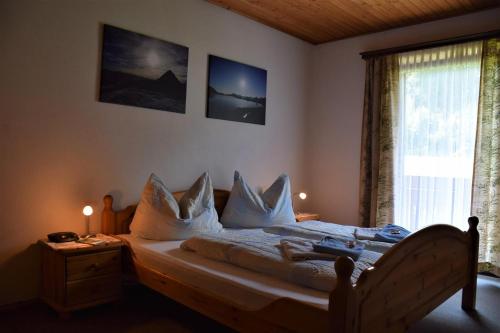 皮恩山口附近施皮塔尔Ferienhof Unterkotgraben的一间卧室配有带白色床单和枕头的床。