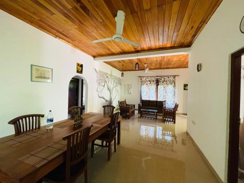 本托塔Rathna Villas的一间带木桌和椅子的用餐室