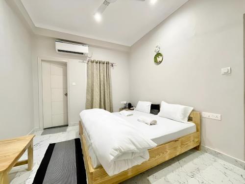 瓦拉纳西Stay Inn Kaashvi (A unit of Admire India Tourism Pvt. Ltd.)的一间卧室配有一张带白色床单的大床