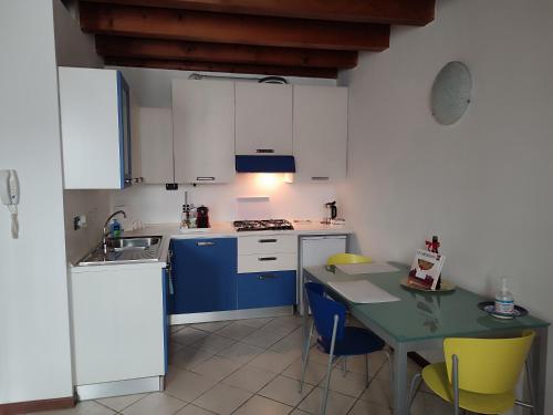 曼托瓦Ca' degli Sposi的厨房配有桌子和蓝白色厨房。
