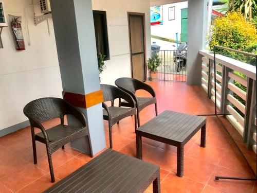 波尔多·格尼拉Badladz Staycation Condos的阳台上的一组椅子和一张桌子