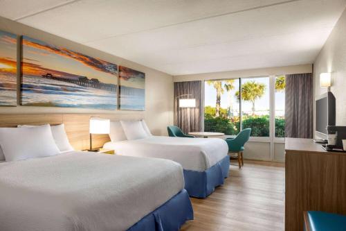 可可比奇可可比奇戴斯酒店的酒店客房设有两张床和电视。