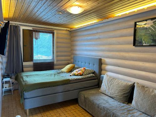 万塔Vantaa Sauna Cottage的一间卧室配有两张床和一张沙发。