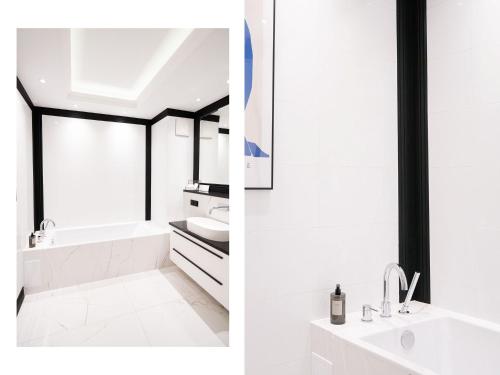 格但斯克Suite Sixteen Szafarnia的白色的浴室设有水槽和浴缸。
