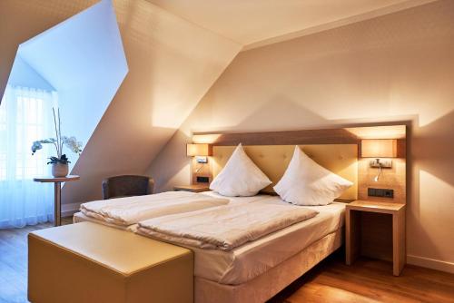 贝尔恩卡斯特尔-库斯德科特韦斯托布酒店的一间卧室配有一张带白色床单的大床