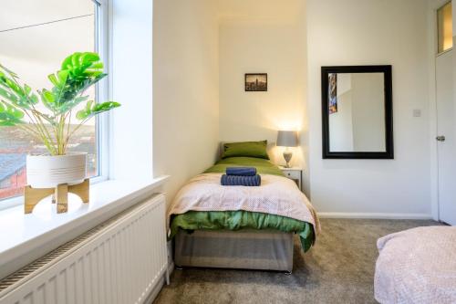 巴特利Home in West Yorkshire, Close to Leeds City Center, Sleeps 3!的一间卧室设有一张床和一个窗口