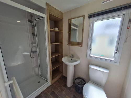 埃克斯茅斯3 Bedroom Deluxe Caravan at Haven Devon Cliffs的带淋浴、卫生间和盥洗盆的浴室