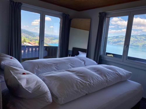 KrattigenEva's Seeblick的带大窗户的客房内的2张白色床