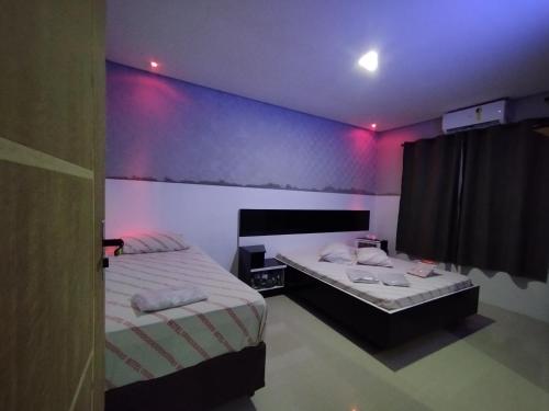 Hotel motel Raiar do Sol santo Amaro客房内的一张或多张床位