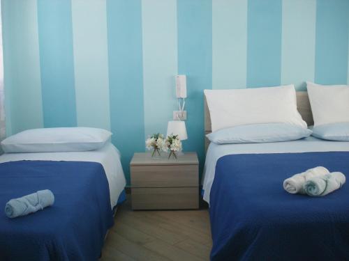 卡梅罗塔码头B&B Margherita的蓝色卧室配有两张带毛巾的床