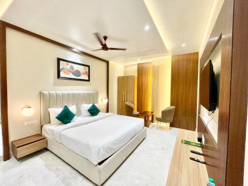 瓦拉纳西HOTEL VEDANGAM INN ! VARANASI - Forɘigner's Choice ! fully Air-Conditioned hotel with Parking availability, near Kashi Vishwanath Temple, and Ganga ghat的酒店客房,配有床和电视