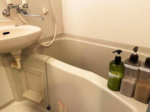 筑紫野市AO Dazaifu / Vacation STAY 61718的浴室配有盥洗盆和白色浴缸。