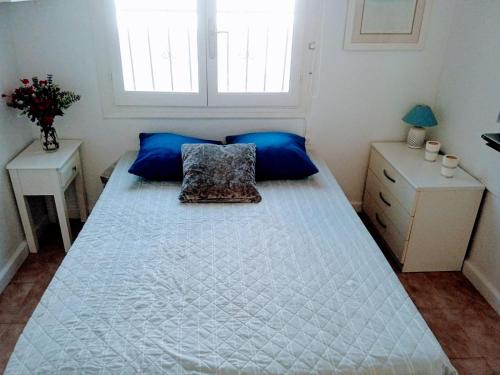 克萨达城casatrace的卧室配有带蓝色枕头的大型白色床