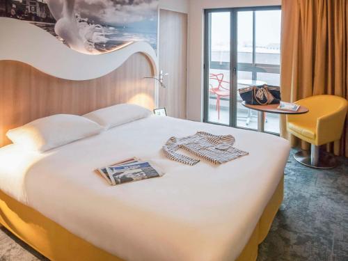 圣马洛圣马洛港宜必思尚品酒店的酒店客房设有一张床和一个阳台。